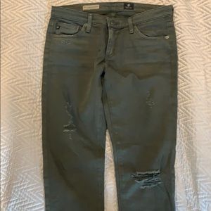 Distressed army green skinny jeans.